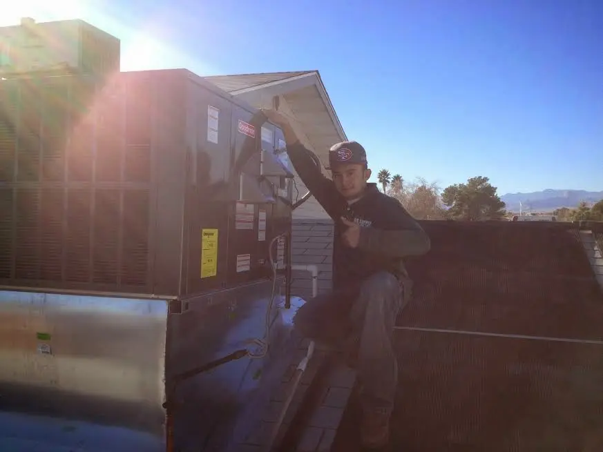 HVAC technician performing HVAC Inspection on a rooftop unit in Parker